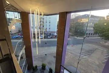 Light-filled atrium with feature lighting overlooking the city
