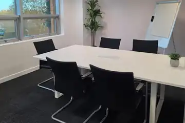 Meeting room with a whiteboard and a window view